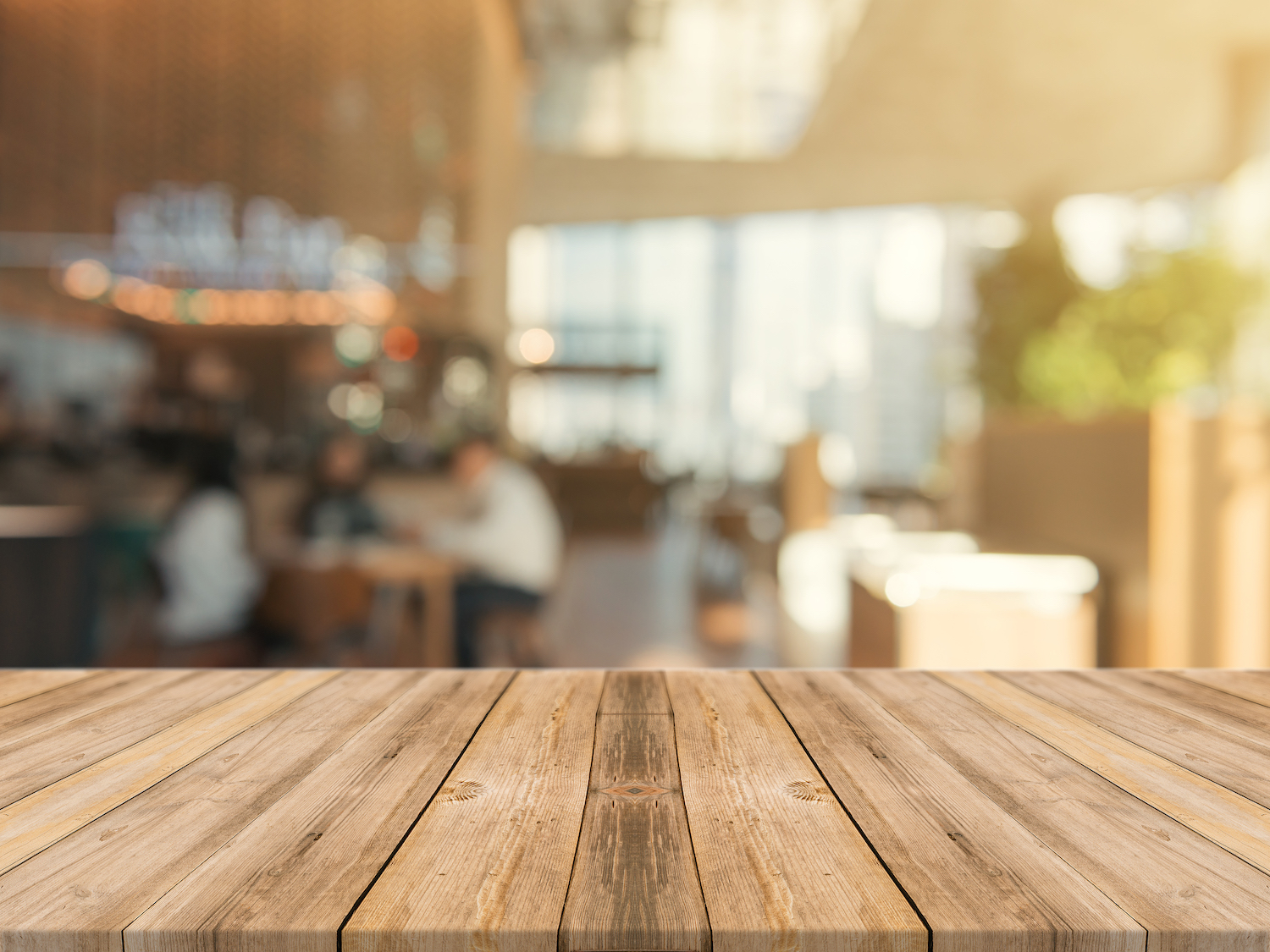 Wooden board empty table top on of blurred background. Perspective